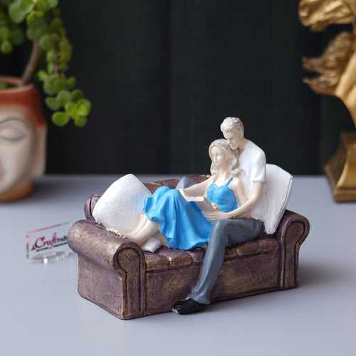 Romantic Couple Statue Sitting on Sofa and Reading Book Decorative Showpiece