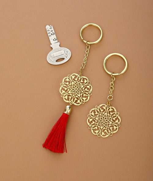 Jaali design Rakhi for bhabi with red hanging tassel cum keychain ring crafted in brass with golden finish