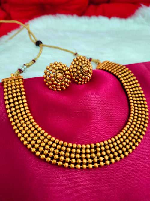 N0561_Classic temple jewelry style crafted design gold plated necklace set embellished with ruby stones .