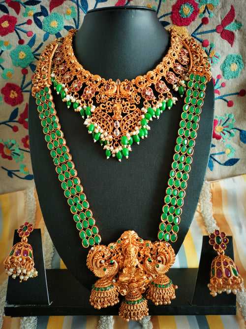 N03070_ Grand classic matte gold polished temple jewelry choker style and Long Haram crafted design gold plated necklace set embellished with ruby and green stones .