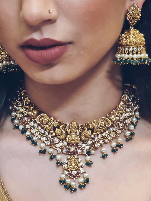 Intricate design polki ,ruby and green stones studded laxmiji set with pearl and green bead drops
