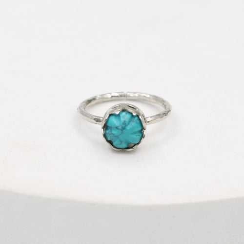 Carved turquoise ring set in sterling Silver, hammered ring band.