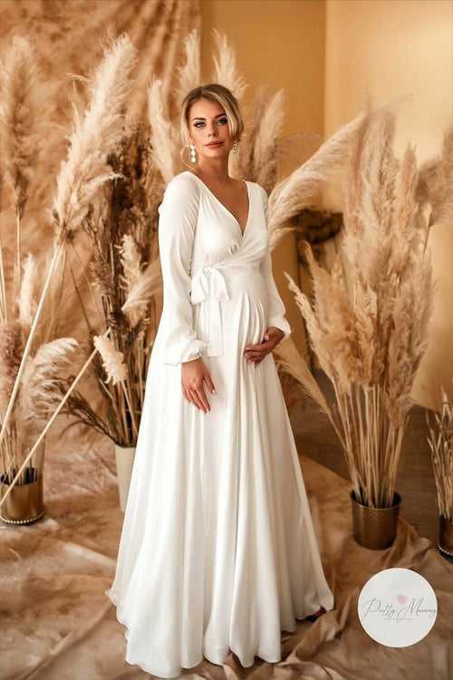 Designarche A white Maternity wear gown is best for the maternity photoshoot.