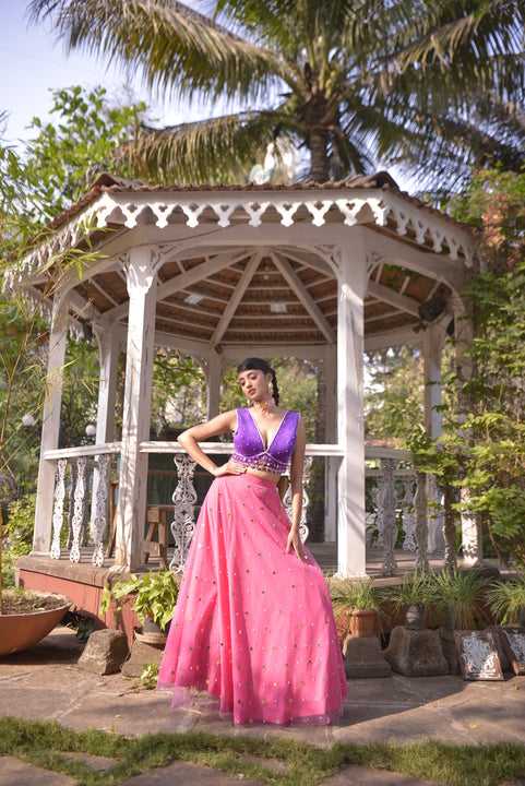 Rani pink net lehenga with purple velvet blouse