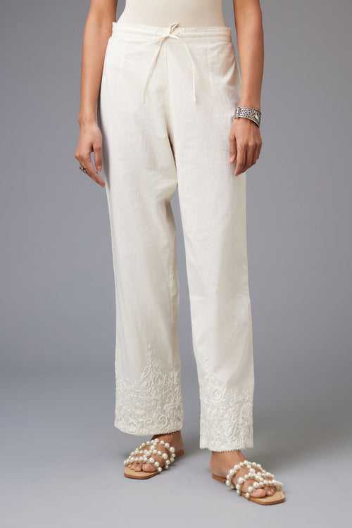 Off-white cotton straight pants with dori embroidery at hem.