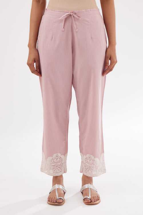 Pink cotton straight pants with appliqué and hand attached sequins detailing at bottom hem.