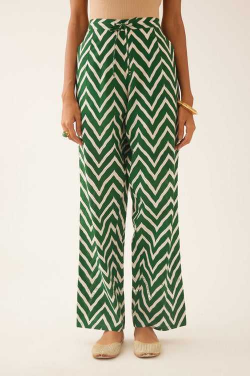 Green & off white cotton hand block printed straight pants detailed with sequin and bead work at hem.