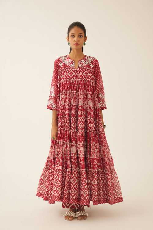 Red hand block printed multi-tiered kurta dress set with 3/4 sleeves, highlighted with sequins, tassels and bead work.