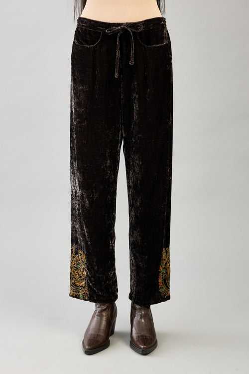 Grey silk velvet hand block printed straight pants with embroidered boota at sides, highlighted with sequins, beads and zari work.