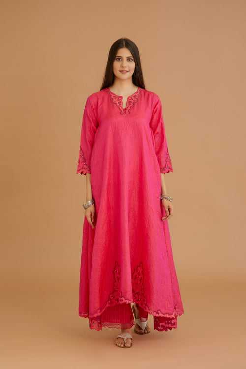 Fuchsia hand crushed silk kurta with cutwork embroidered asymmetric hem, highlighted with hand attached mirrors.