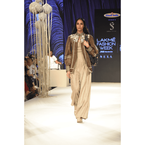 Brown khadi jacket with embroidered yoke and stripe jumpsuit with stitchline detais on bodice