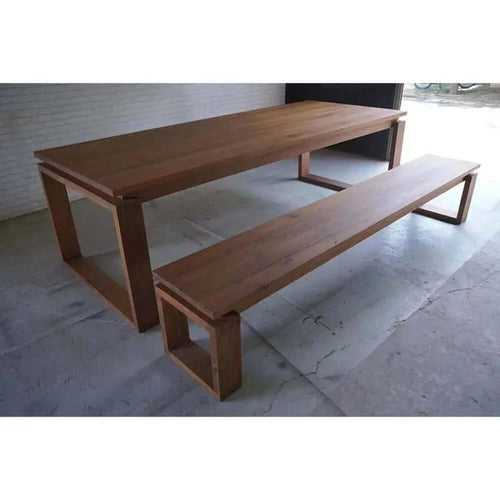 Contemporary floating teak dining table with a bench