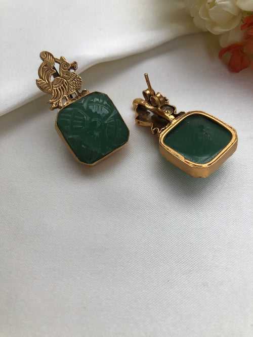 Antique polish peacock earrings with a natural carved green stone