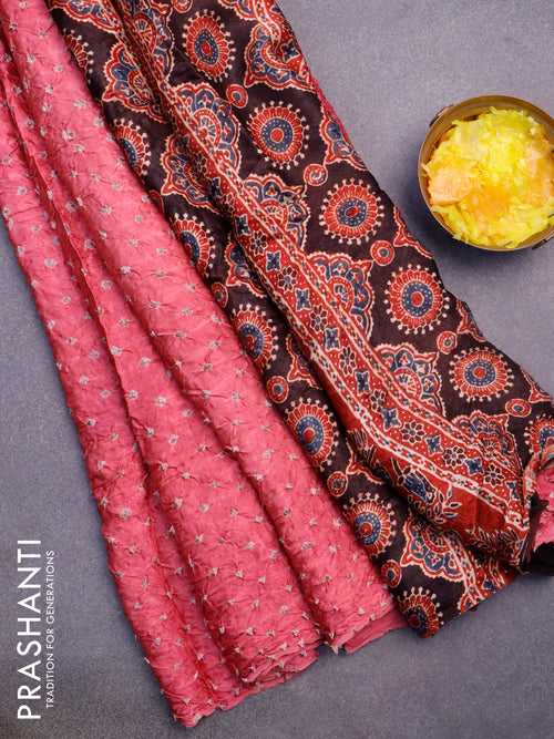 Modal silk saree pink shade and maroon with allover bandhani prints and ajrakh printed pallu