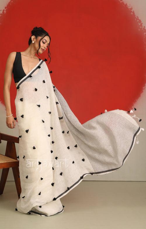 A striking White Linen Saree With woven in Pom Poms