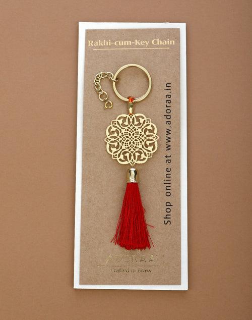 Jaali design Rakhi for bhabi with red hanging tassel cum keychain ring crafted in brass with golden finish