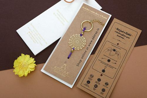 Lotus design Rakhi cum keychain ring for Bhai/brother crafted in brass with golden finish