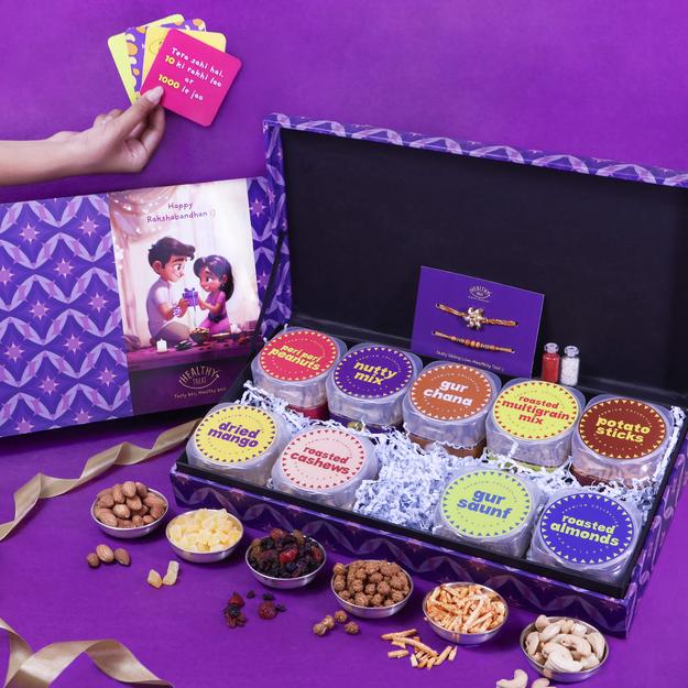 Guilt-Free Rakhi Surprise Hamper Rakhi Gift Box | Pack of 9 snacks, 1 Pair Rakhi, 1 Roli chawal, 4 Stickers