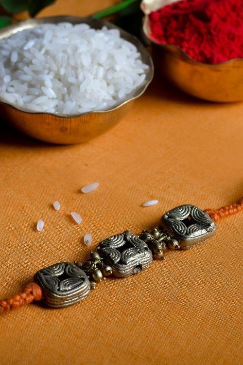 Miharu Handmade Dokra Orange Thread Rakhi (RH012)