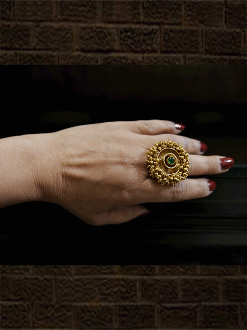 Antique gold finish adjustable ring with beaded lace on edge and stone in the middle