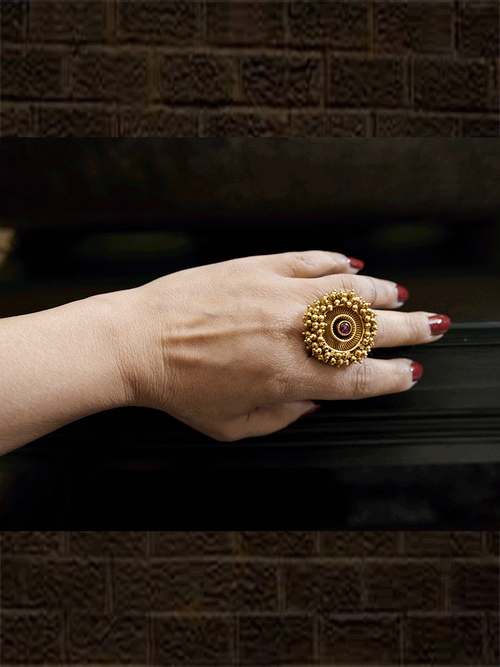 Antique gold finish adjustable ring with beaded lace on edge and stone in the middle