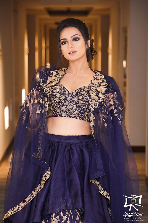 Layered organza embroideredlehenga with bustier blouse and tulle cape