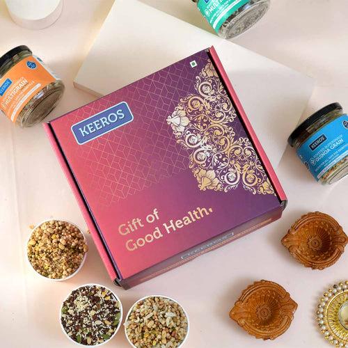 Keeros Healthy Bhai Dooj Gift for Brother with Roli Moli Chandan Tikka Chawal Mishri Pack & 2 Beautiful Diyas | Combo of Sweet & Salted, Tasty & Nutritious Super Snacks in Elegant Glass Jars Packed in Premium Gift Hamper