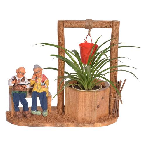 The Weaver's Nest Wishing Well Planter with Figurines sitting on Bench