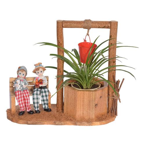 The Weaver's Nest Wishing Well Planter with Figurines sitting on Bench