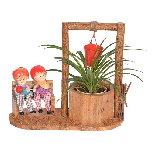 The Weaver's Nest Wishing Well Planter with Figurines sitting on Bench