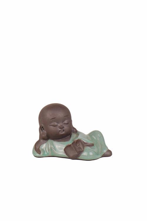 Lying buddha holding book decor