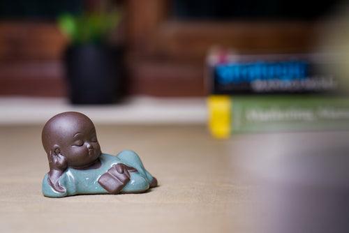 Lying buddha holding book decor