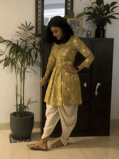 Cotton green discharge printed ,bodice fitted kurta with pleats at waist paired with off-white coloured cotton dhoti pant