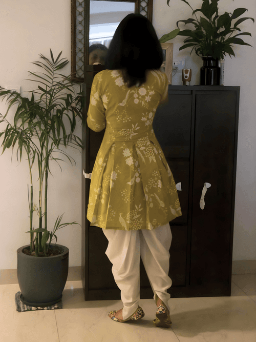 Cotton green discharge printed ,bodice fitted kurta with pleats at waist paired with off-white coloured cotton dhoti pant