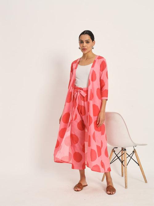 Red and pink polka cape paired with highwaisted pants.