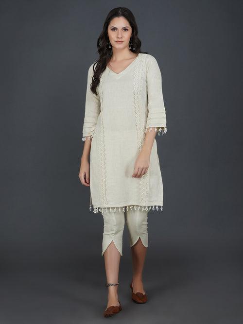 Set of off white cotton flex kurta with lace work on princess seam, tiered sleeves with co-ordinated petal pants