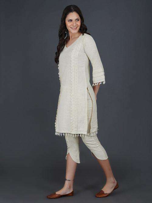 Set of off white cotton flex kurta with lace work on princess seam, tiered sleeves with co-ordinated petal pants