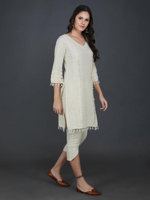 Set of off white cotton flex kurta with lace work on princess seam, tiered sleeves with co-ordinated petal pants