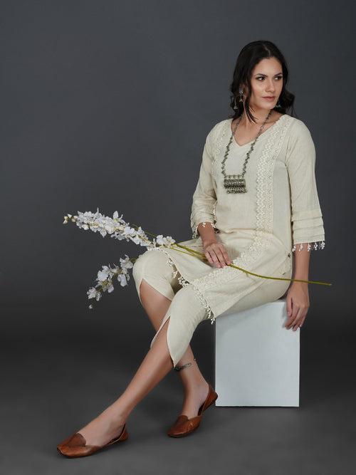 Set of off white cotton flex kurta with lace work on princess seam, tiered sleeves with co-ordinated petal pants