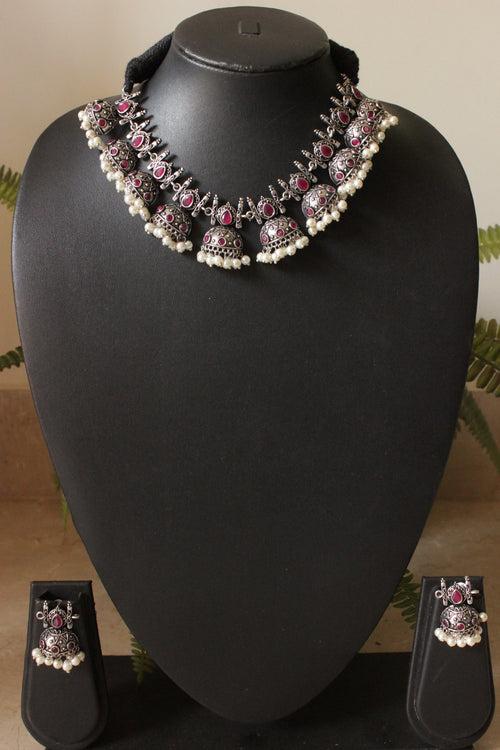 Oxidised Finish Choker Necklace Set Embedded with Red Stones and Jhumka Earrings