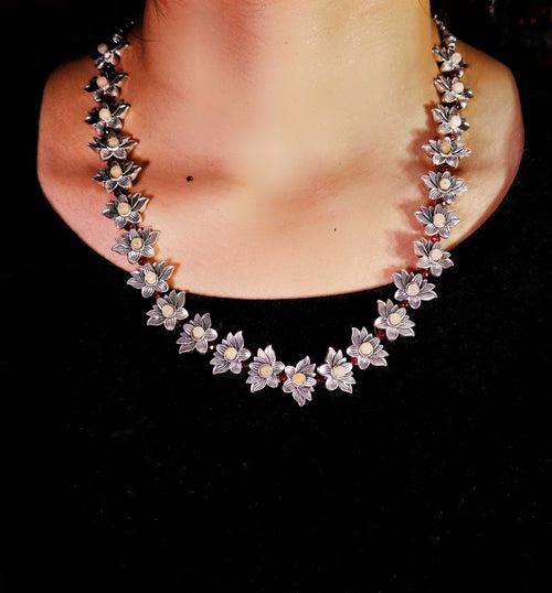 Nakshi Handcrafted German Silver & Red Crystals Lotus Shape Necklace Set