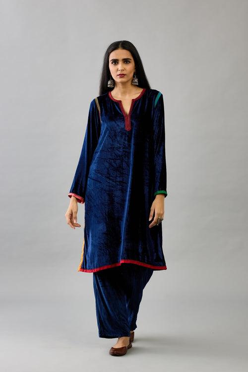 Blue silk velvet short A-line kurta set with multi colored silk facing and embroidery.