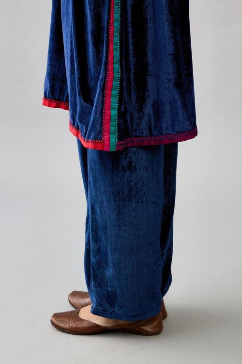 Blue silk velvet short A-line kurta set with multi colored silk facing and embroidery.