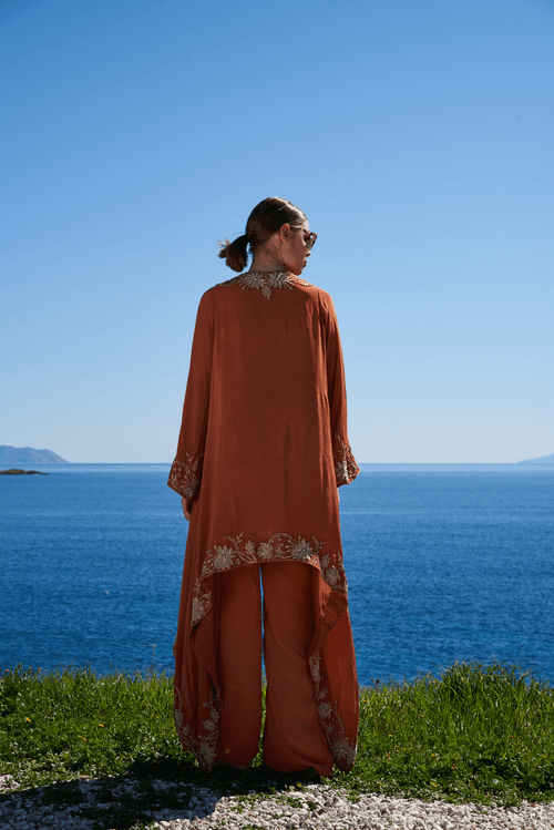 Rust crepe embroidered asymmetrical cape with rust crepe pants