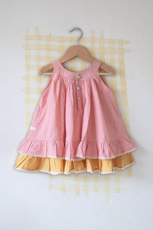 ‘Pocketful of sunsets' sleeveless dress in peach pink with yellow frill in handwoven cotton