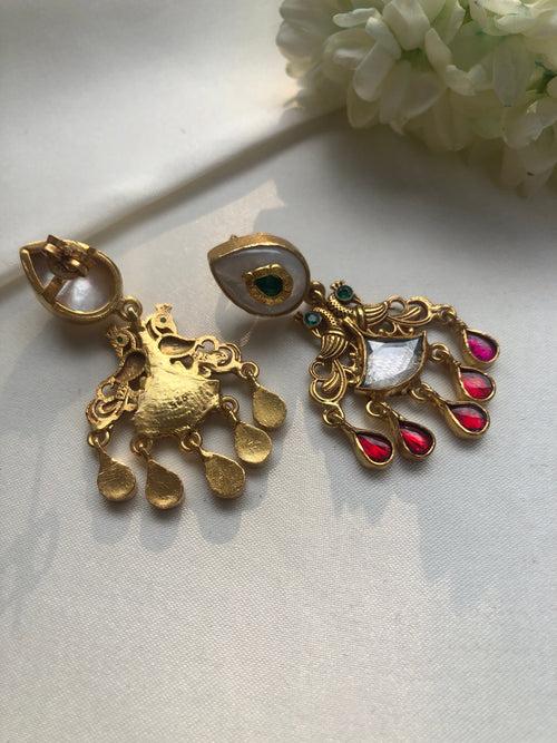 Antique polish earrings with  green kundans and ruby pearl drops