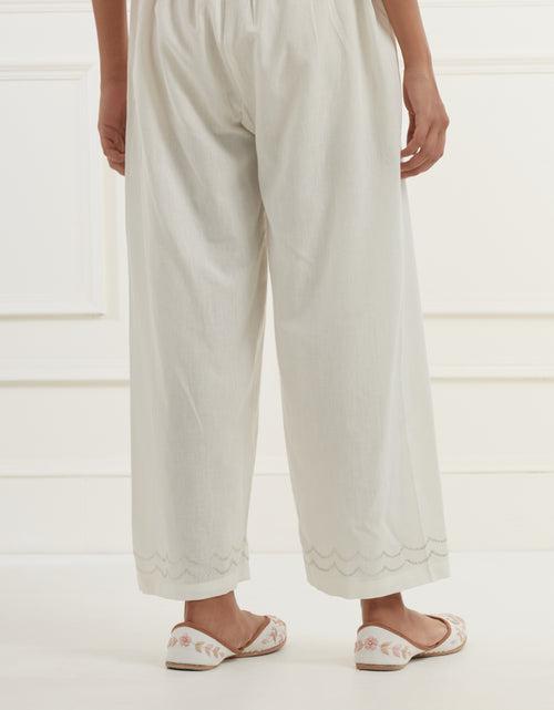 Off white chanderi cotton flax pants in a straight  fit with silver pittan embroidery at the hem