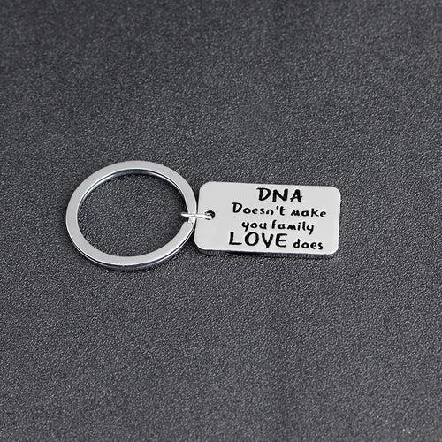 DNA DOESNT MAKE YOU FAMILY LOVE DOES Family Keychain