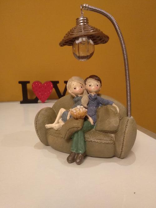 Couple Sitting on Sofa